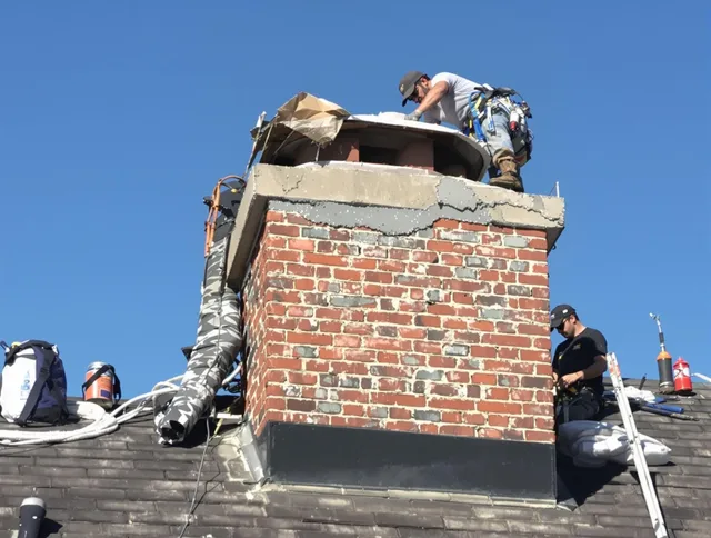 Norfolk Chimney Sweep installing a custom chimney crown in Norfolk, MA