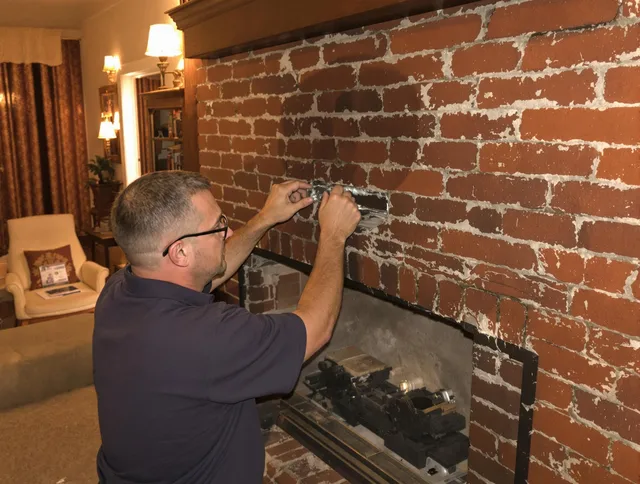 Norfolk Chimney Sweep expert fixing a fireplace in Norfolk, MA
